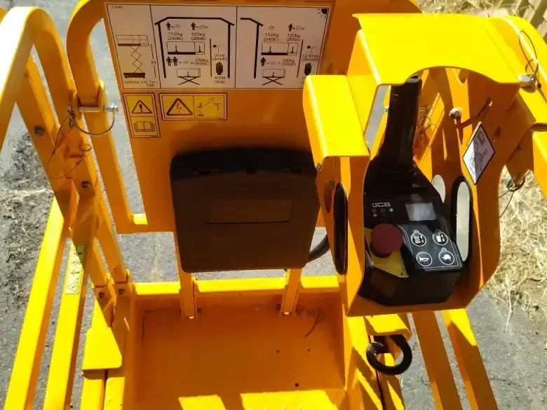 Scissor lift platform deck showing the proportional control box and guardrails